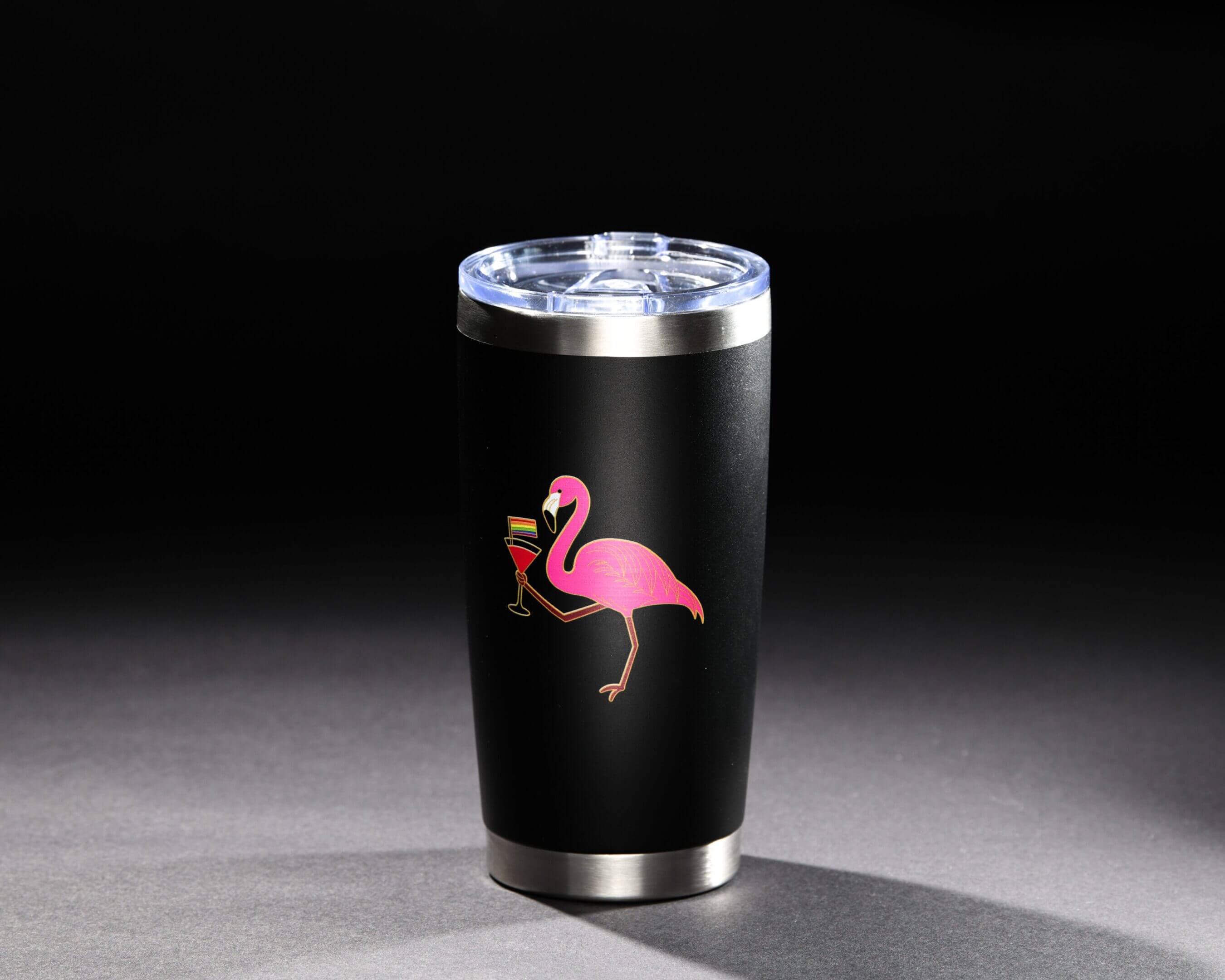Black tumbler with a pink flamingo holding a cocktail glass design.