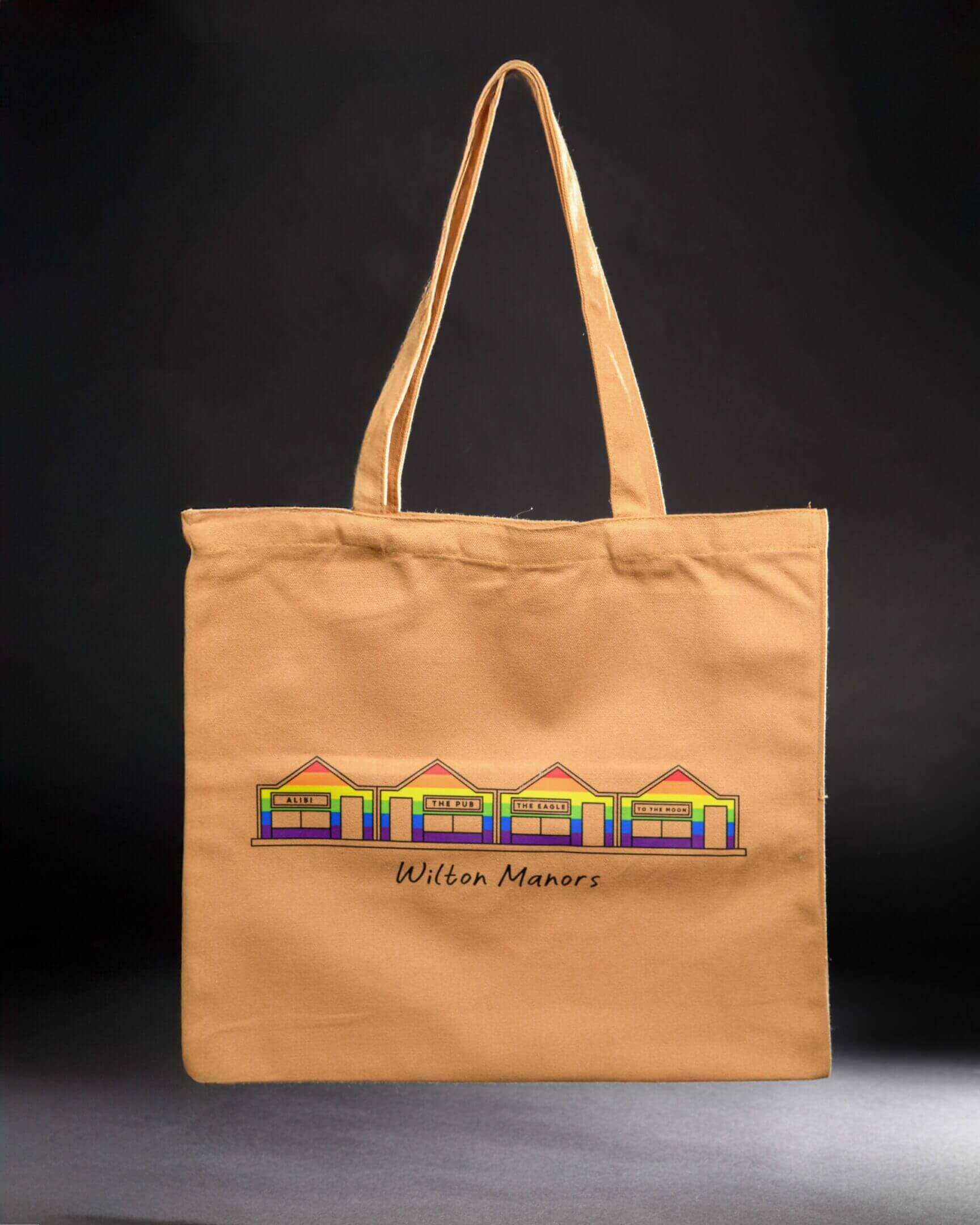 Beige tote bag with colorful house design.