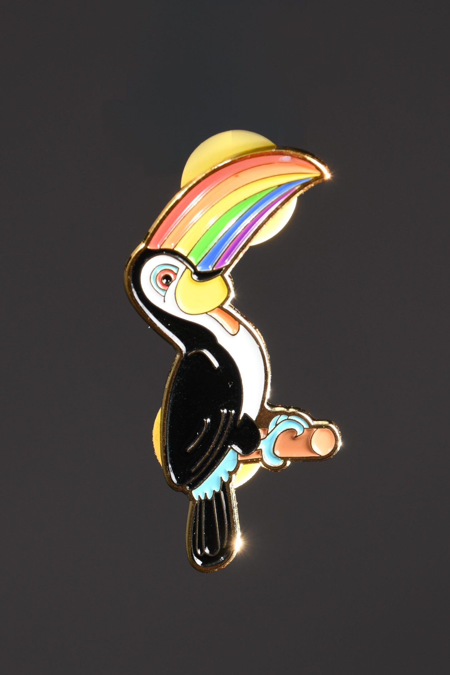 Toucan pin with a rainbow beak.