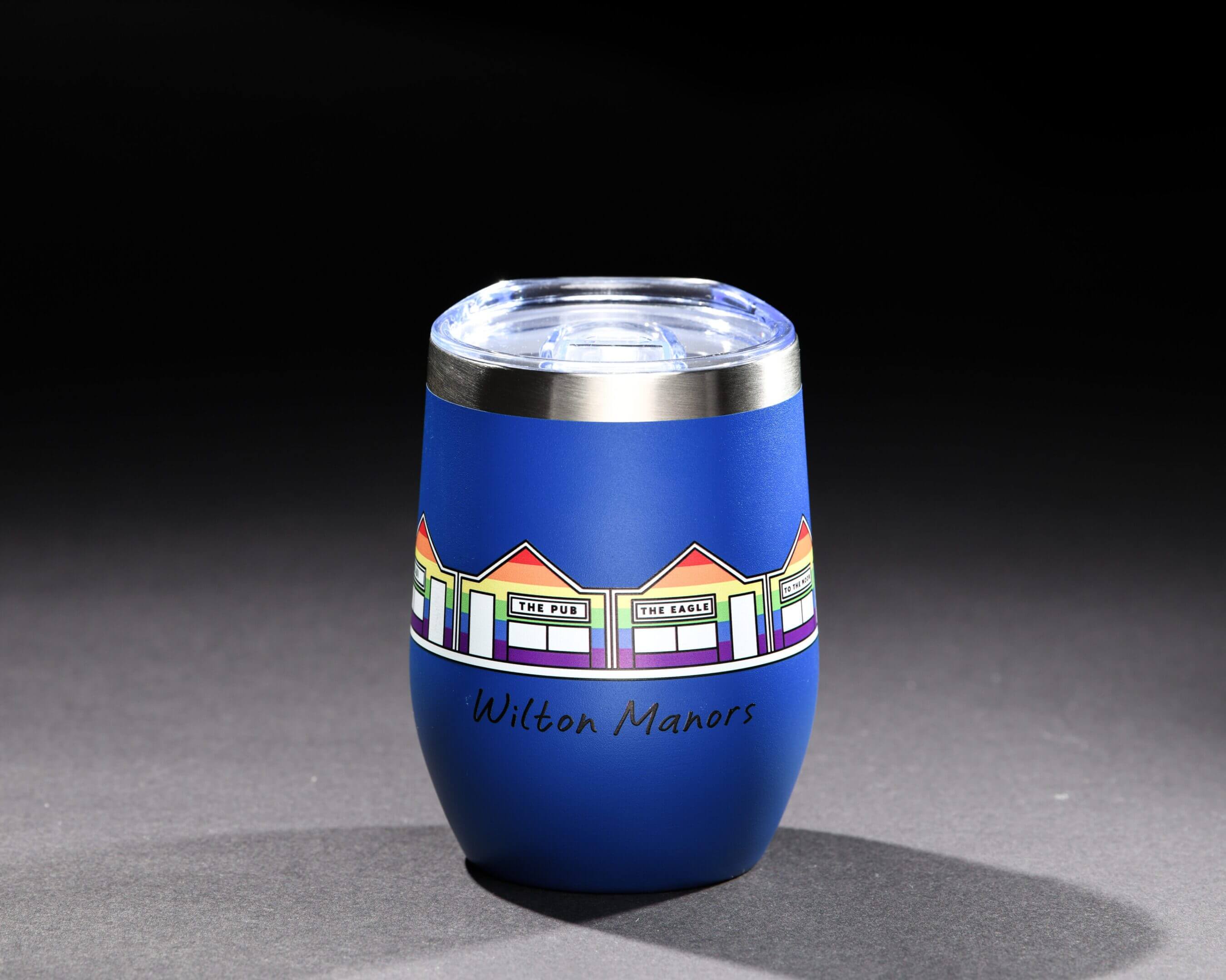 A vibrant blue decorative vase with colorful geometric patterns around its center.